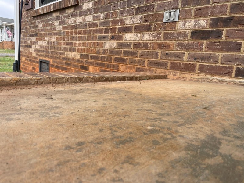 Front porch concrete slab sinking and pulling away from the house wall