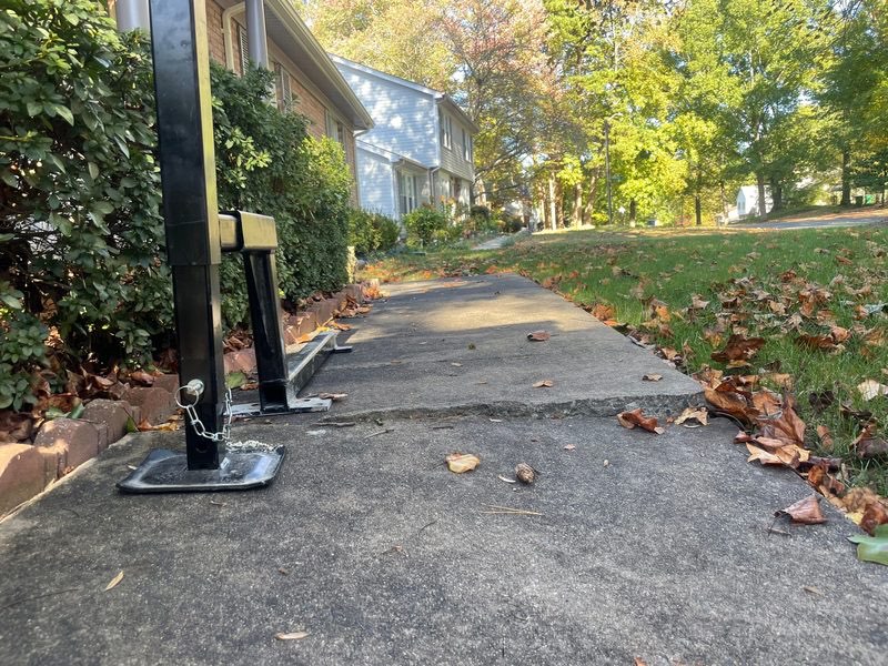 Uneven sidewalk sections creating a trip hazard between concrete slabs