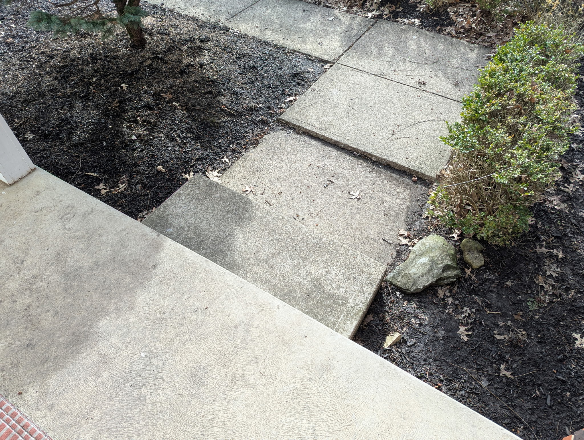 Uneven sidewalk sections creating a trip hazard between concrete slabs