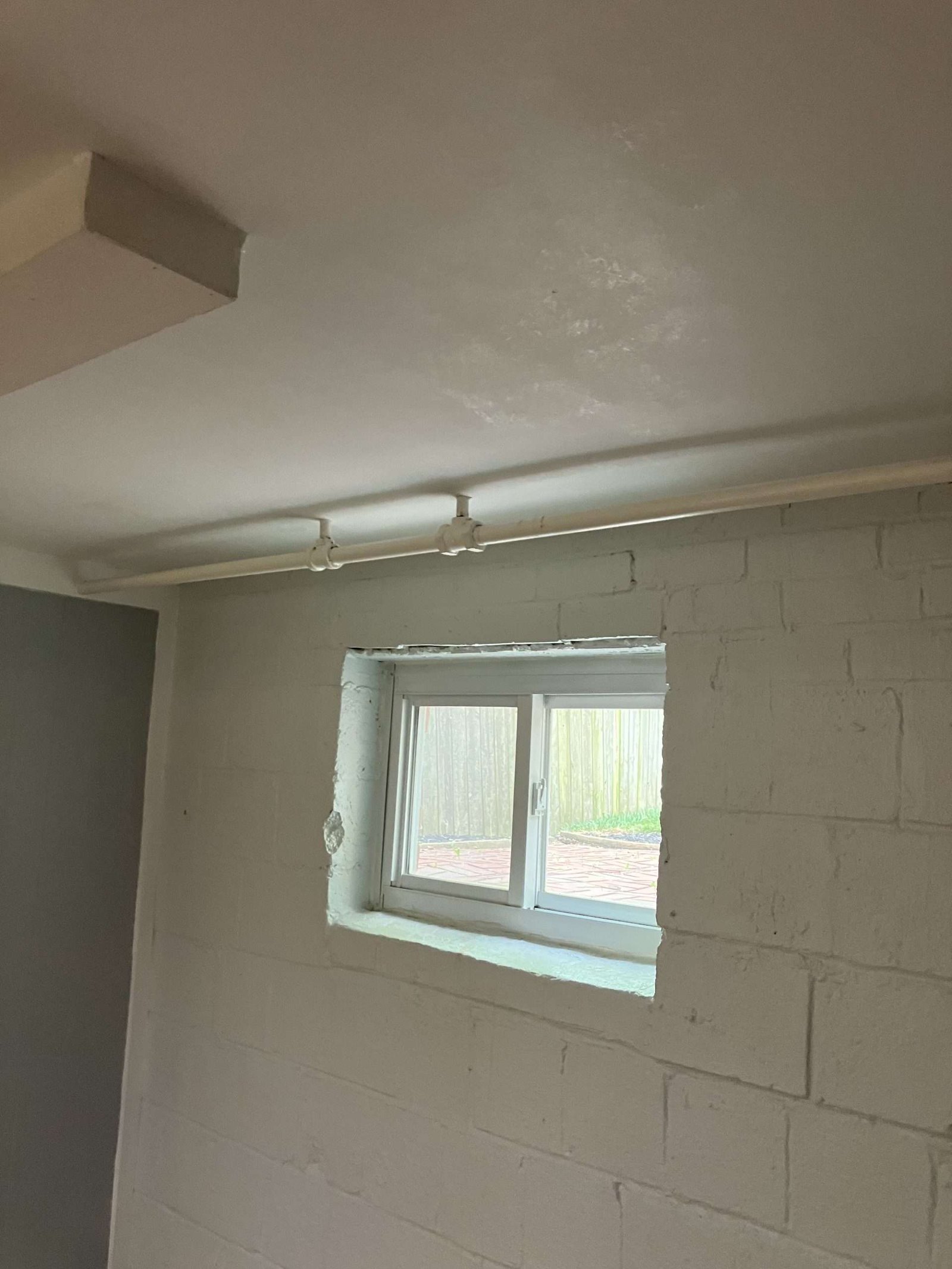 Small sealed basement window that does not meet egress code