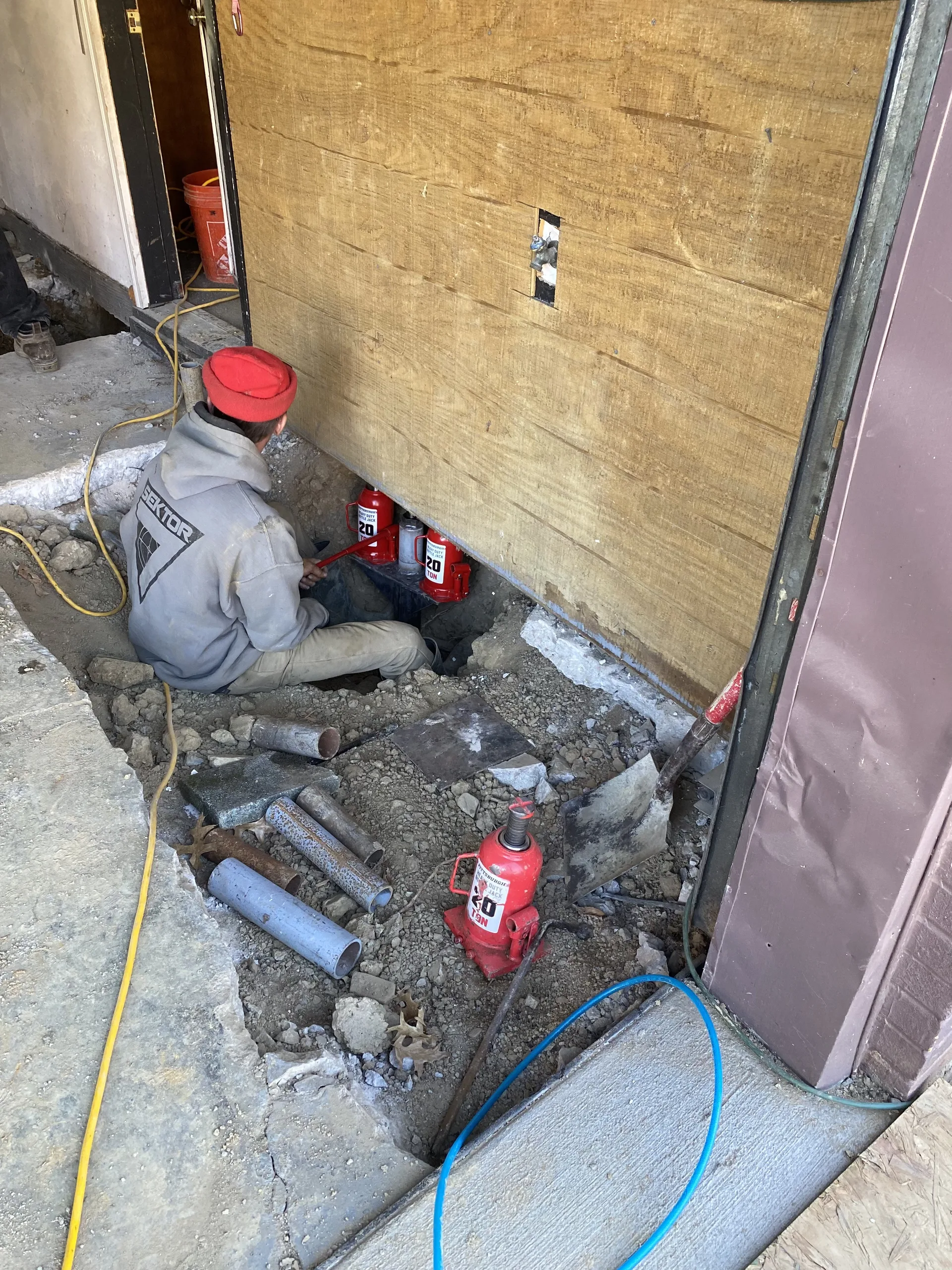 Queen Foundation Repair crew member working on a foundation repair project