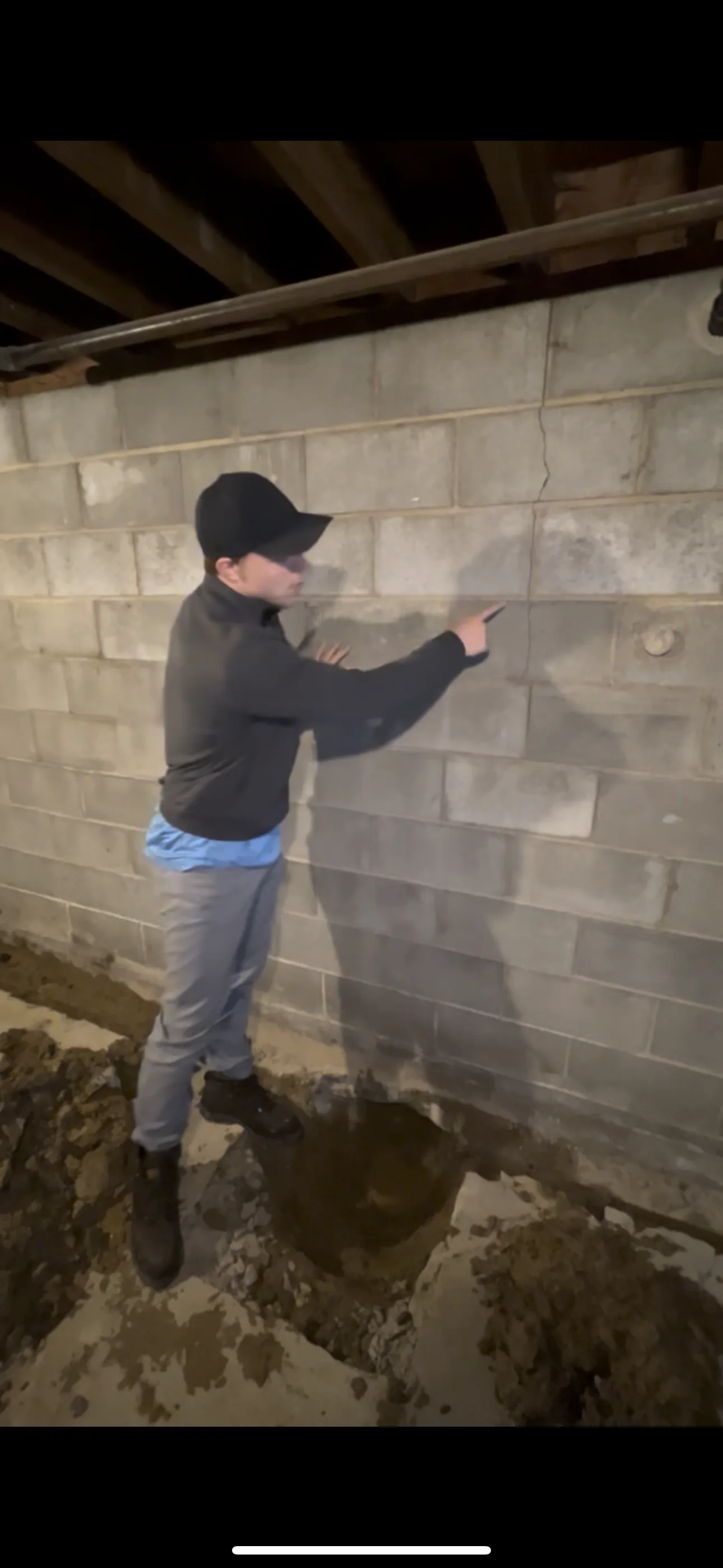 Queen Foundation Repair technician assessing a foundation crack