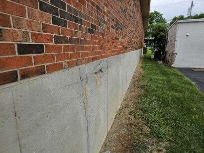 Bowing basement wall repair with carbon fiber or steel reinforcements