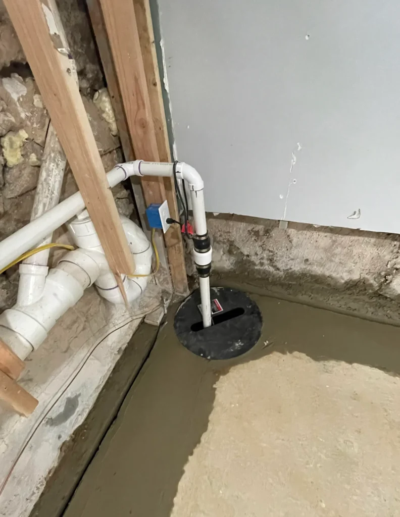 Basement sump pump installation with drainage trench and new discharge piping